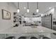 Bright kitchen with granite countertops, stylish lighting, stainless appliances, and a convenient sliding barn door at 9019 S County Line Rd, Lithia, FL 33547