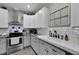 Bright kitchen featuring white cabinets, stainless steel appliances, and ample countertop space at 9019 S County Line Rd, Lithia, FL 33547