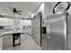 Bright kitchen with stainless steel refrigerator, pantry with sliding door, and ample counter space at 9019 S County Line Rd, Lithia, FL 33547