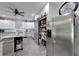Bright kitchen with stainless steel refrigerator, pantry with sliding door, and ample counter space at 9019 S County Line Rd, Lithia, FL 33547