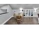 This living room features a wood laminate floor, recessed lights, and a wooden dining table at 9019 S County Line Rd, Lithia, FL 33547