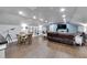 Open-concept living room with plenty of recessed lights, wood floors, and built-in bookcase at 9019 S County Line Rd, Lithia, FL 33547