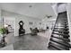 Spacious living room featuring a staircase, fireplace, and seamless flow to adjacent rooms at 9019 S County Line Rd, Lithia, FL 33547