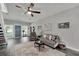 Comfortable living room with a ceiling fan, a gray couch, and a blue entry door at 9019 S County Line Rd, Lithia, FL 33547