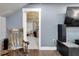 Living room featuring wood floors and blue-gray walls with a doorway to storage at 9019 S County Line Rd, Lithia, FL 33547