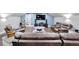 Beautiful living room with dark brown seating, hardwood floors, and a blue accent wall at 9019 S County Line Rd, Lithia, FL 33547