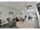 Spacious living room with stylish furnishings that transitions into the dining room at 9019 S County Line Rd, Lithia, FL 33547
