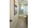 A modern bathroom with white marble-style tile, brushed bronze fixtures, and a shower-tub combo at 9308 45Th N St, Pinellas Park, FL 33782