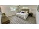A serene bedroom showcasing neutral decor, wood laminate flooring, and bright windows at 9308 45Th N St, Pinellas Park, FL 33782
