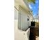 Side exterior showing white siding, a compact AC unit, and partial yard at 9308 45Th N St, Pinellas Park, FL 33782