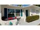 Beautiful home exterior with turquoise shutters, white trim, and a colorful fish decoration at 9308 45Th N St, Pinellas Park, FL 33782