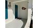 Inviting porch with a bright teal door and decorative fish artwork at 9308 45Th N St, Pinellas Park, FL 33782