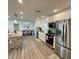 Bright kitchen with stainless steel appliances, a kitchen island, and an open layout to the dining area at 9308 45Th N St, Pinellas Park, FL 33782