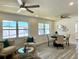 Cozy living area with stylish furniture, large windows, and a modern ceiling fan at 9308 45Th N St, Pinellas Park, FL 33782