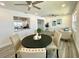 Bright living area with a black dining table and views of the kitchen and sitting area at 9308 45Th N St, Pinellas Park, FL 33782