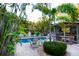 Inviting backyard retreat with a screened lanai, pool, and lush tropical landscaping at 1208 Bay Pine Blvd, Indian Rocks Beach, FL 33785