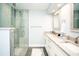 Bright bathroom with double sink vanity and glass door shower at 1208 Bay Pine Blvd, Indian Rocks Beach, FL 33785