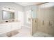 Bright bathroom featuring a double sink vanity, and a walk-in shower at 1208 Bay Pine Blvd, Indian Rocks Beach, FL 33785