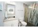 Bright bathroom featuring a single sink vanity, toilet, and a modern tiled shower at 1208 Bay Pine Blvd, Indian Rocks Beach, FL 33785