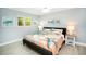 Bright bedroom with a king bed, coastal decor, and soft, neutral tones at 1208 Bay Pine Blvd, Indian Rocks Beach, FL 33785