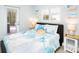 Bright bedroom with a king bed, beach-themed bedding, and access to the pool area at 1208 Bay Pine Blvd, Indian Rocks Beach, FL 33785