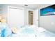 Bright bedroom features a king bed with beach-themed bedding, a closet, and a TV at 1208 Bay Pine Blvd, Indian Rocks Beach, FL 33785