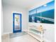 Bright foyer with a decorative door, console table, and bridge artwork at 1208 Bay Pine Blvd, Indian Rocks Beach, FL 33785