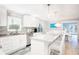 Beautiful, bright, modern kitchen with a large island, stainless steel appliances, and backsplash at 1208 Bay Pine Blvd, Indian Rocks Beach, FL 33785