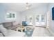 Cozy living room featuring neutral tones, a ceiling fan, and patio door access at 1208 Bay Pine Blvd, Indian Rocks Beach, FL 33785