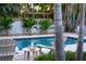 Relaxing pool area with poolside seating and lush tropical landscaping at 1208 Bay Pine Blvd, Indian Rocks Beach, FL 33785