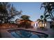 Home boasts a large, private pool, outdoor cabana, and lush landscaping, perfect for relaxing evenings at 1208 Bay Pine Blvd, Indian Rocks Beach, FL 33785