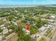 Aerial view shows the property situated near the coast in a community with mature trees at 121 Pennsylvania Ave, Palm Harbor, FL 34683