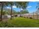 Spacious backyard featuring a well-kept lawn, privacy fence, and a charming gazebo with seating at 121 Pennsylvania Ave, Palm Harbor, FL 34683