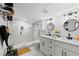 Modern bathroom with dual vanities, sleek fixtures, and a glass-enclosed walk-in shower at 121 Pennsylvania Ave, Palm Harbor, FL 34683