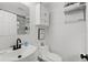 Clean bathroom featuring a white vanity, toilet, and cabinet with an interesting print at 121 Pennsylvania Ave, Palm Harbor, FL 34683