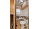 Shot of an RV bathroom with toilet, small sink, light, drawers, and storage at 121 Pennsylvania Ave, Palm Harbor, FL 34683