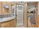 Interior of a bathroom featuring a sink, cabinets, shower with glass door, and view into the rest of the recreational vehicle at 121 Pennsylvania Ave, Palm Harbor, FL 34683