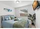 Cozy bedroom with soft blue bedding, bright window, and entertainment center at 121 Pennsylvania Ave, Palm Harbor, FL 34683