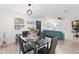 Bright dining room with glass table, black chairs, and a view to the living area and kitchen at 121 Pennsylvania Ave, Palm Harbor, FL 34683