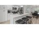 Modern kitchen features stainless steel appliances, sleek countertops, and a breakfast bar with seating at 121 Pennsylvania Ave, Palm Harbor, FL 34683