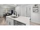 Bright kitchen island has stainless steel dishwasher, sink, and plenty of counter space at 121 Pennsylvania Ave, Palm Harbor, FL 34683