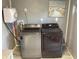 Gray laundry room featuring a hot water heater and Samsung washer and dryer set at 121 Pennsylvania Ave, Palm Harbor, FL 34683