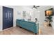 Bright living room featuring a comfortable blue sofa, white walls, and modern wood-look flooring at 121 Pennsylvania Ave, Palm Harbor, FL 34683