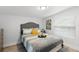 Comfortable bedroom with stylish decor, a plush bed, and ample natural light streaming through the window at 121 Pennsylvania Ave, Palm Harbor, FL 34683