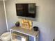 Small interior office with a TV above a display table with decor at 121 Pennsylvania Ave, Palm Harbor, FL 34683