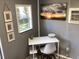 Photo of a simple office featuring a desk, chair, window, and artwork at 121 Pennsylvania Ave, Palm Harbor, FL 34683