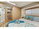 RV bedroom with comfortable queen bed, adjacent bathroom, and wood-look cabinetry at 121 Pennsylvania Ave, Palm Harbor, FL 34683