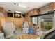 RV interior featuring wood-look flooring, comfortable seating, multiple TVs, and ample storage at 121 Pennsylvania Ave, Palm Harbor, FL 34683