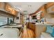 Cozy RV kitchen featuring wood cabinets, modern appliances, sink, and dining area with booth seating at 121 Pennsylvania Ave, Palm Harbor, FL 34683