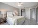 Bedroom features bright window, ceiling fan, calming colors, wood-look flooring, and closet at 1400 Gandy N Blvd # 1701, St Petersburg, FL 33702